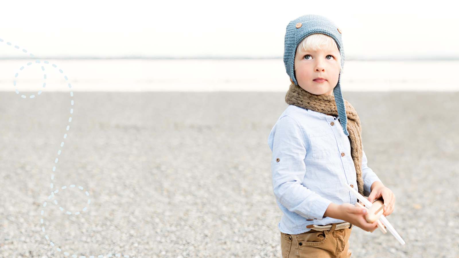 Child holding toy plane