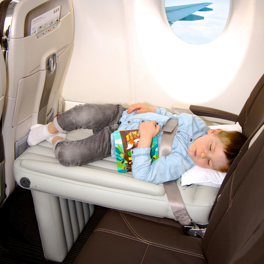 Toddler sleeping on the plane on the inflatable airplane bed Flyaway Kids Bed